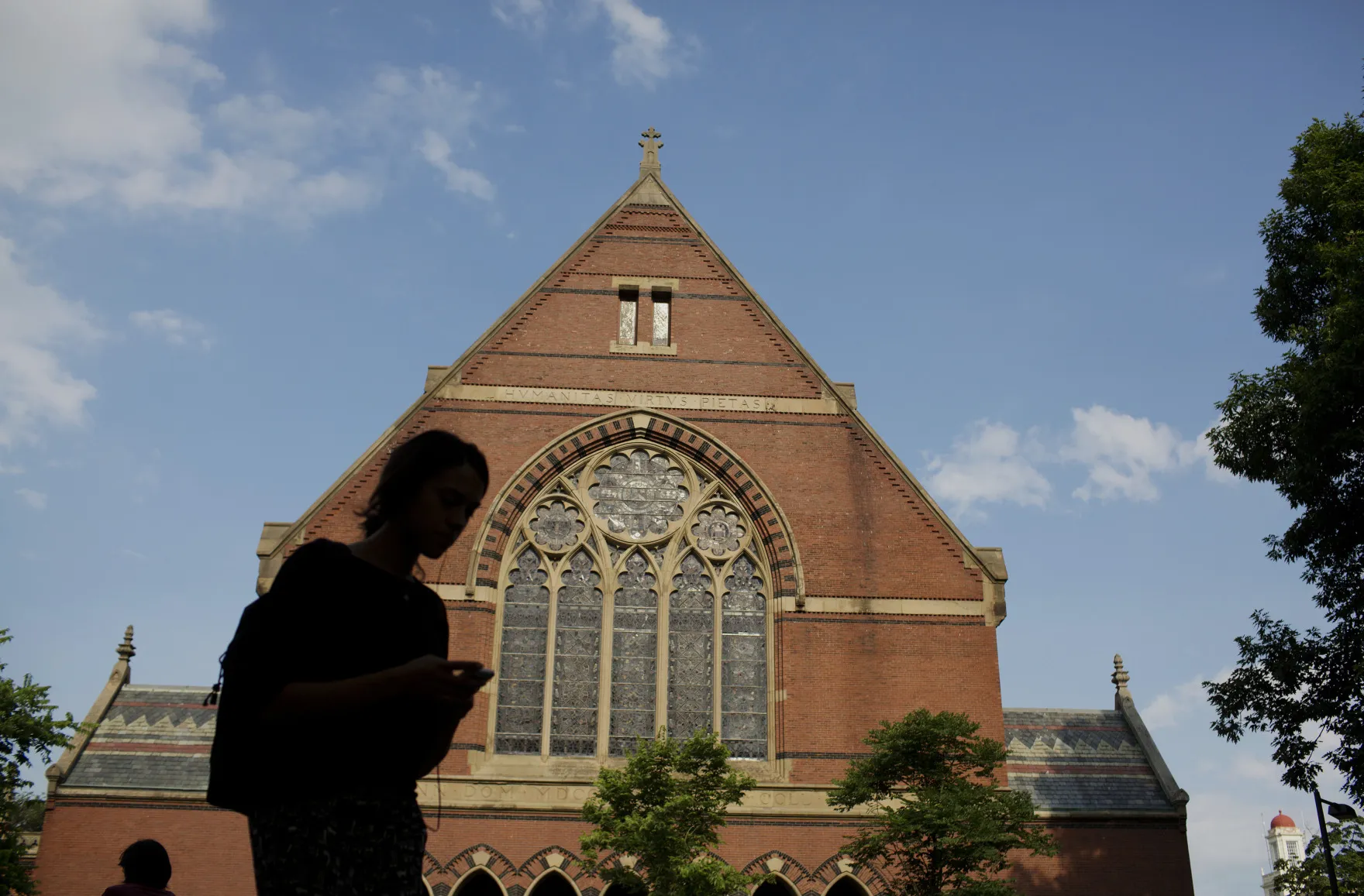 A person walks past Memorial Hall at the Harvard University campus in Cambridge, Massachusetts.