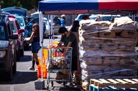 Residents in vehicles wait in line at a food distribution site in El Paso, Texas.