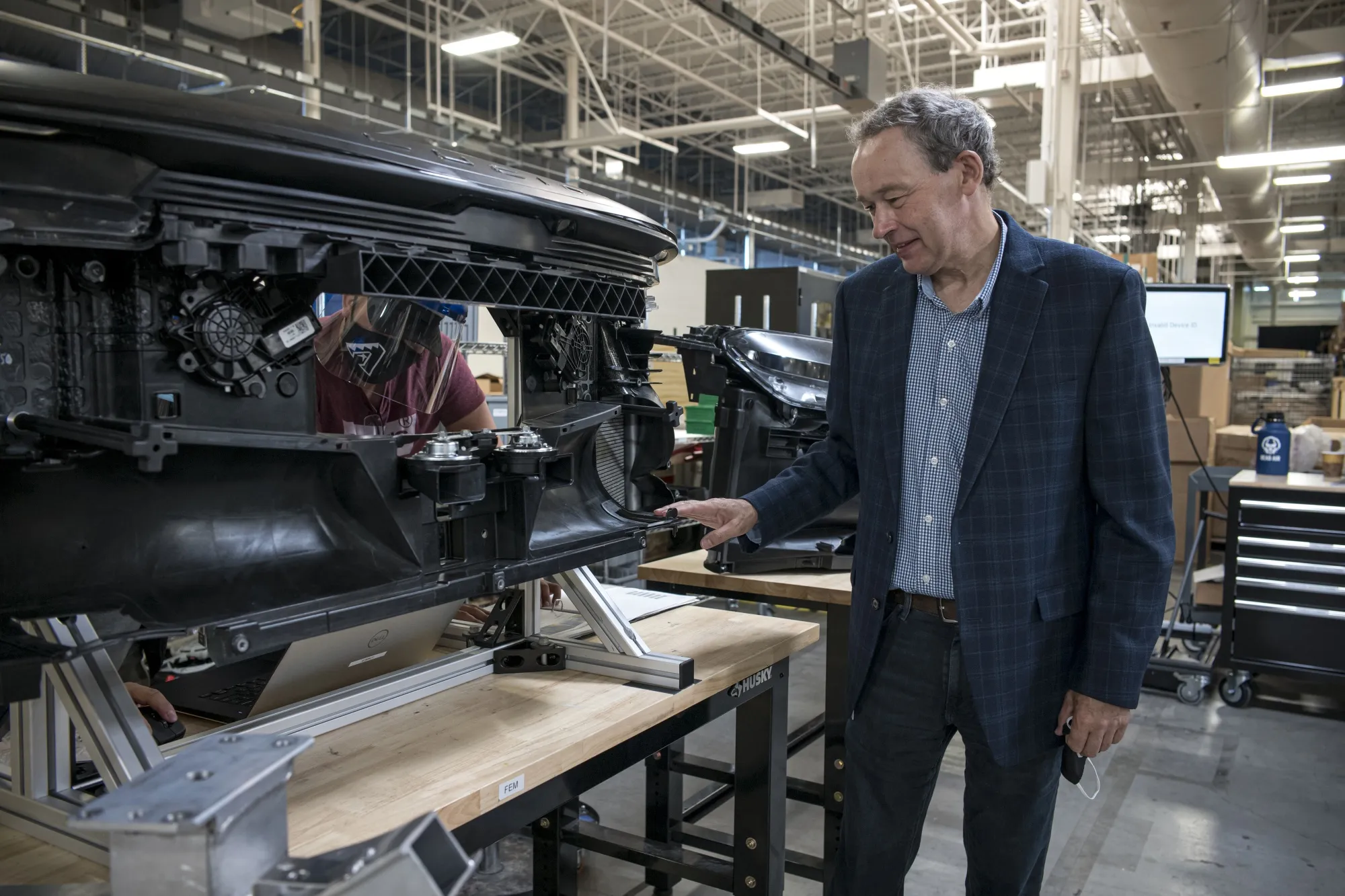 Peter Rawlinson, chief executive officer of Lucid Motors Inc., inspects a prototype electric vehicle.
