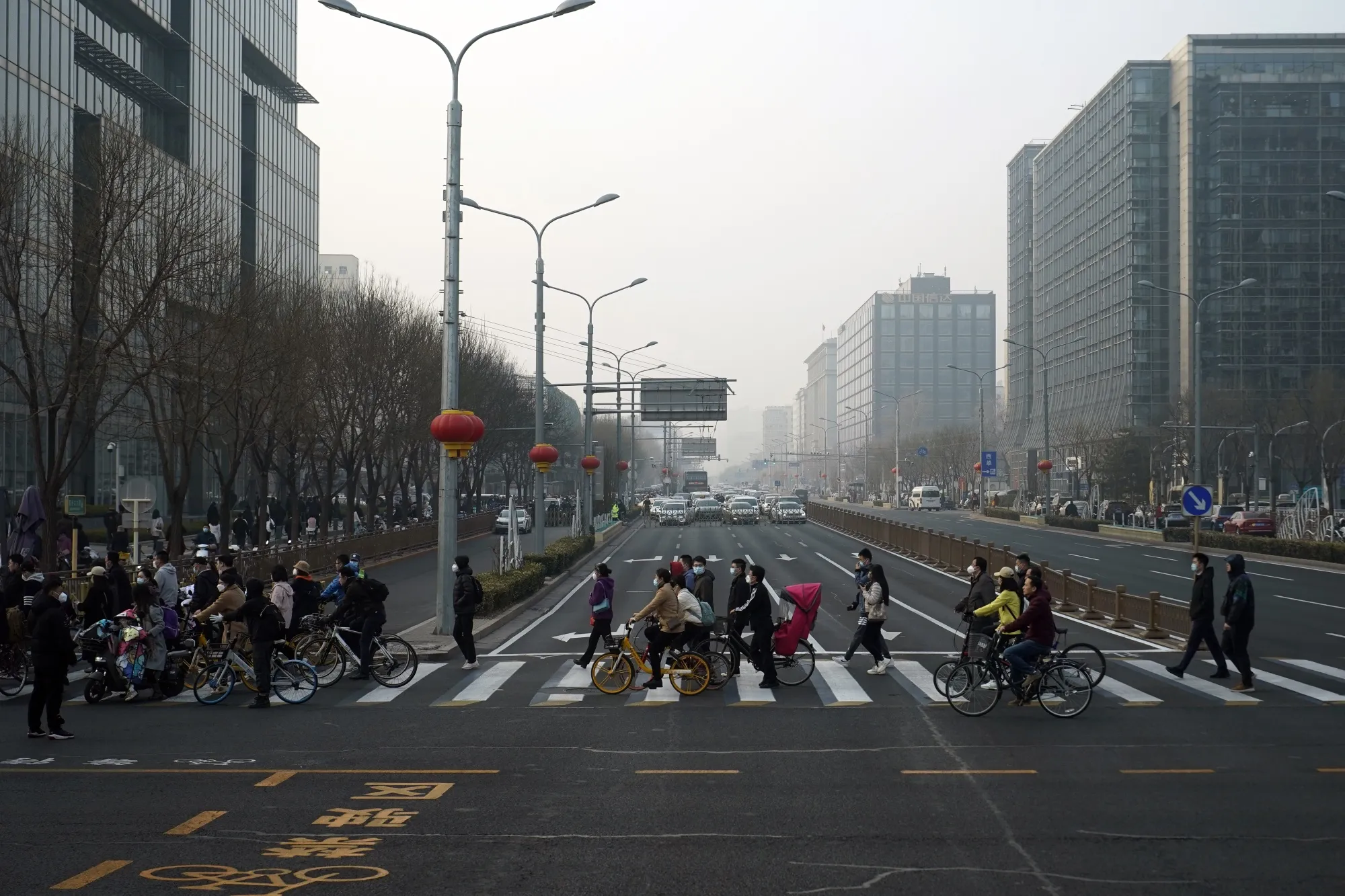 Pedestrians cross a road in Beijing, China.
