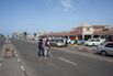 People cross the road heading towards a shopping mall
