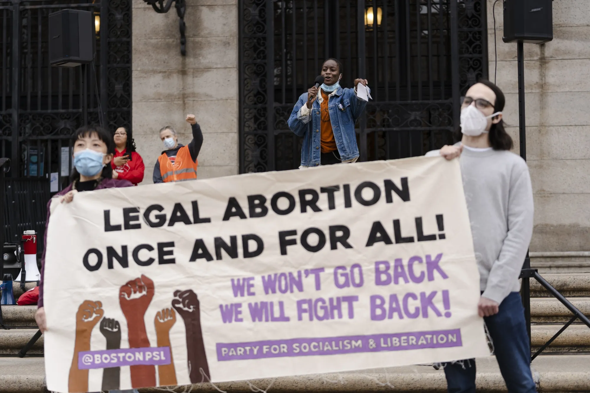 Abortion-rights demonstrators hold signs during a rally in Boston on May 6, 2022.