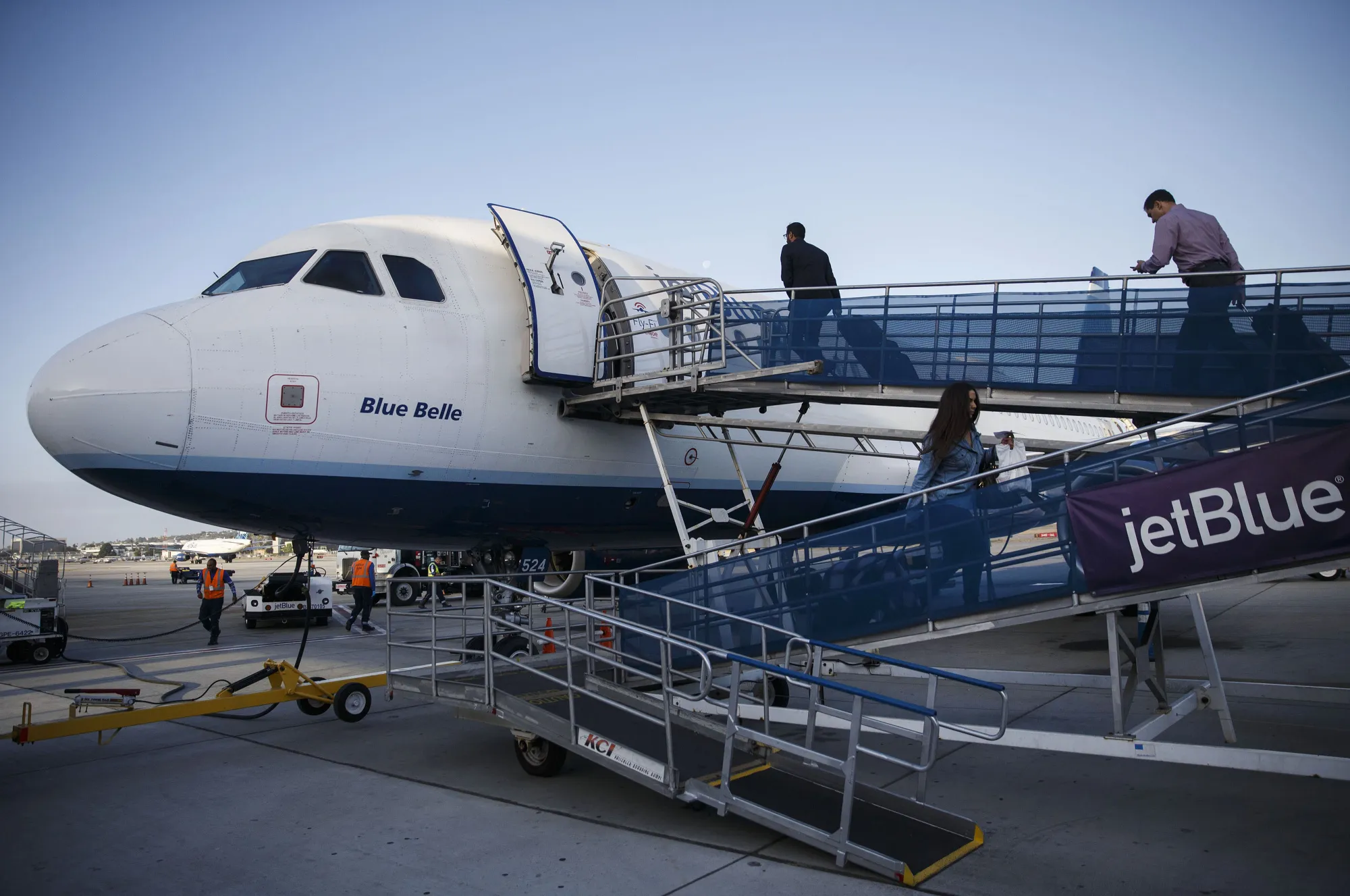 Travelers board a JetBlue aircraft on the tarmac at Long Beach Airport&nbsp;in Long Beach, California.