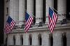 American flags hang on display outside the New York Stock Exchange (NYSE) in New York, U.S., on Monday, March 5, 2018. U.S. stocks turned higher and Treasuries erased gains as investors speculated that President Donald Trump's tough tariff talk won't translate into the most severe protectionist policies.