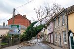 A fallen tree rests against a house blocking a road in Sudbury, Suffolk.