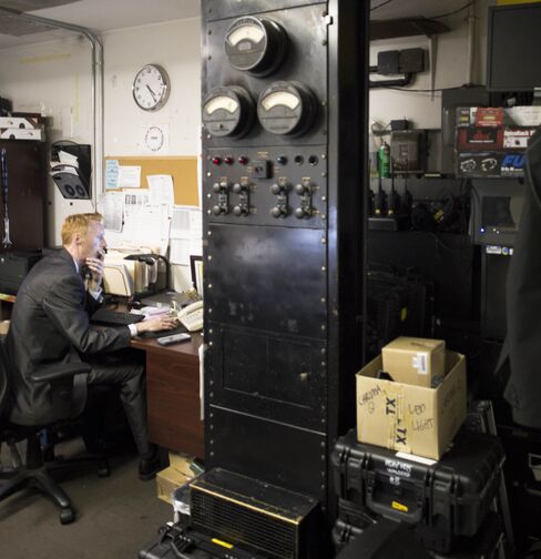 A Waldorf Astoria employee works amid audio relics from the 1930s.