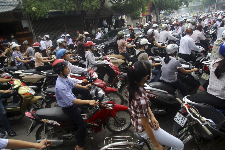 Throngs of motorbikes crowd the streets in Hanoi's rush hour traffic.