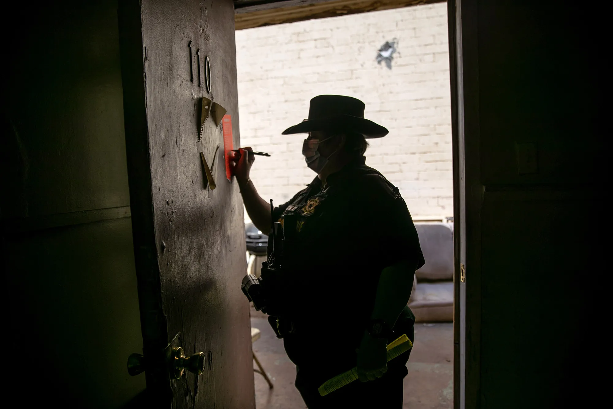 A constable signs an eviction order in Phoenix, Arizona on Oct. 7, 2020.&nbsp;