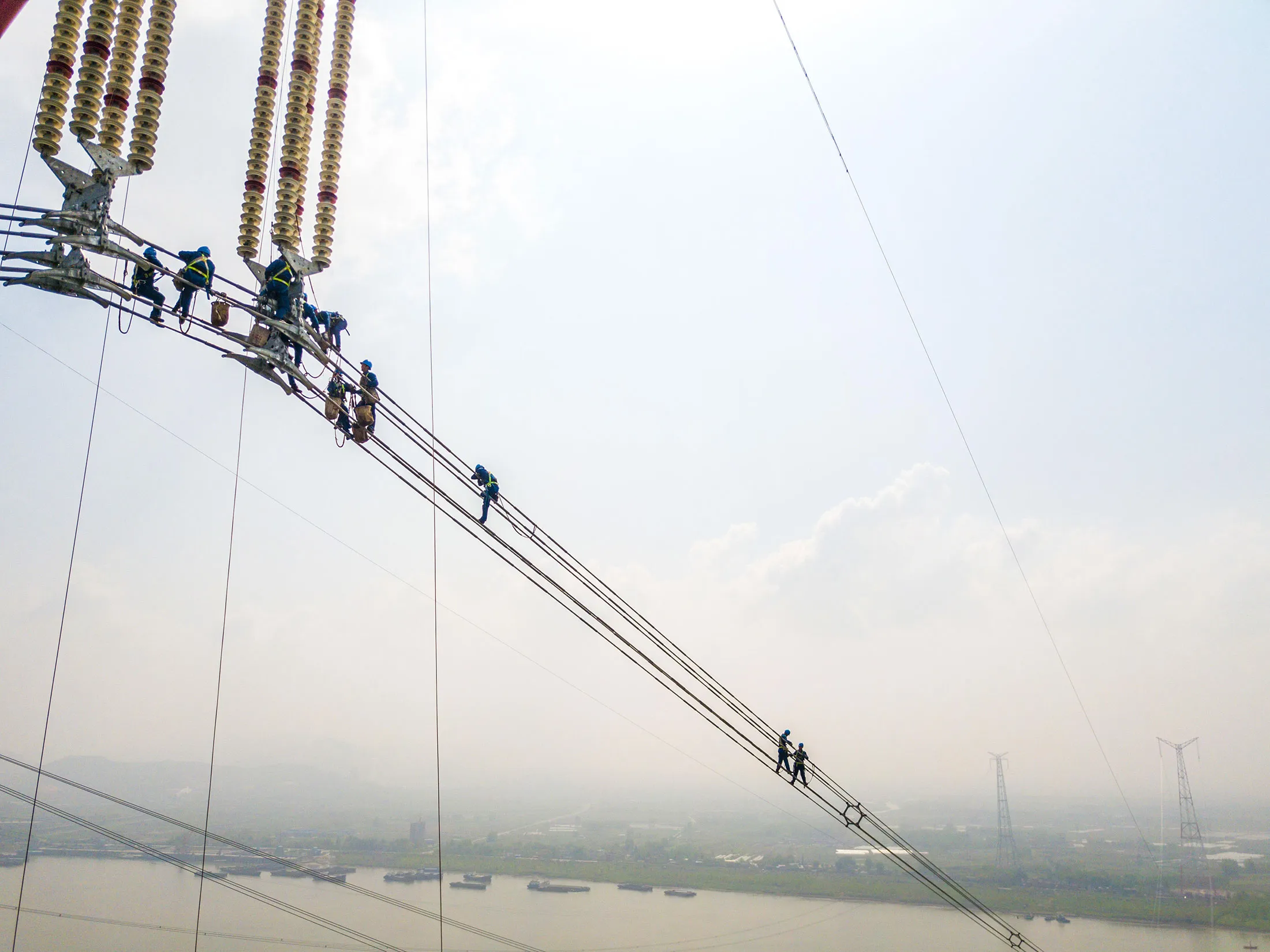 Chinese workers on the Changji-Guquan UHVDC transmission link along the Yangtze River.