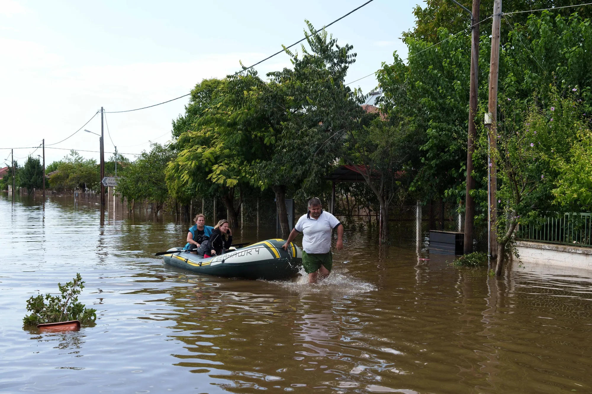 Residents rescued by boat from flooded homes following heavy rain in Palamas in Karditsa region, Greece.