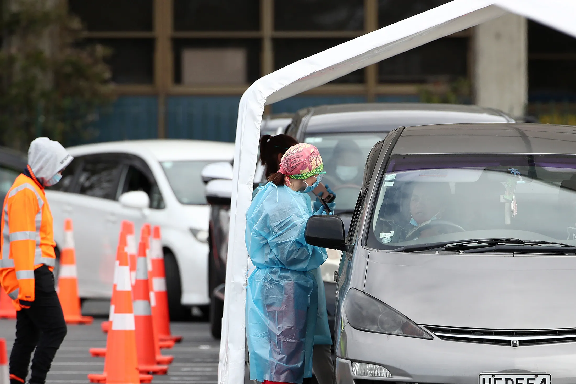 Health workers test people arriving at the Covid-19 testing facility in Otara town centre in Auckland, New Zealand on Aug. 14. 