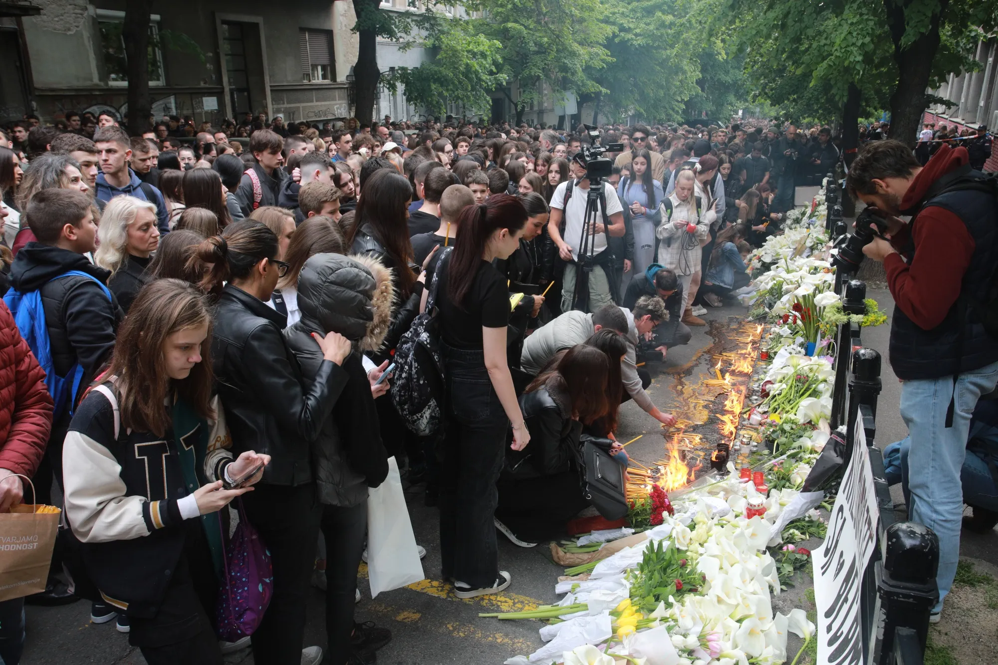 People pay their respects to the victims of the school shooting.