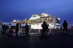 Members of the media work in front of the Diamond Princess cruise ship, operated by Carnival Corp., sitting docked in Yokohama, Japan, on Wednesday, Feb. 12,