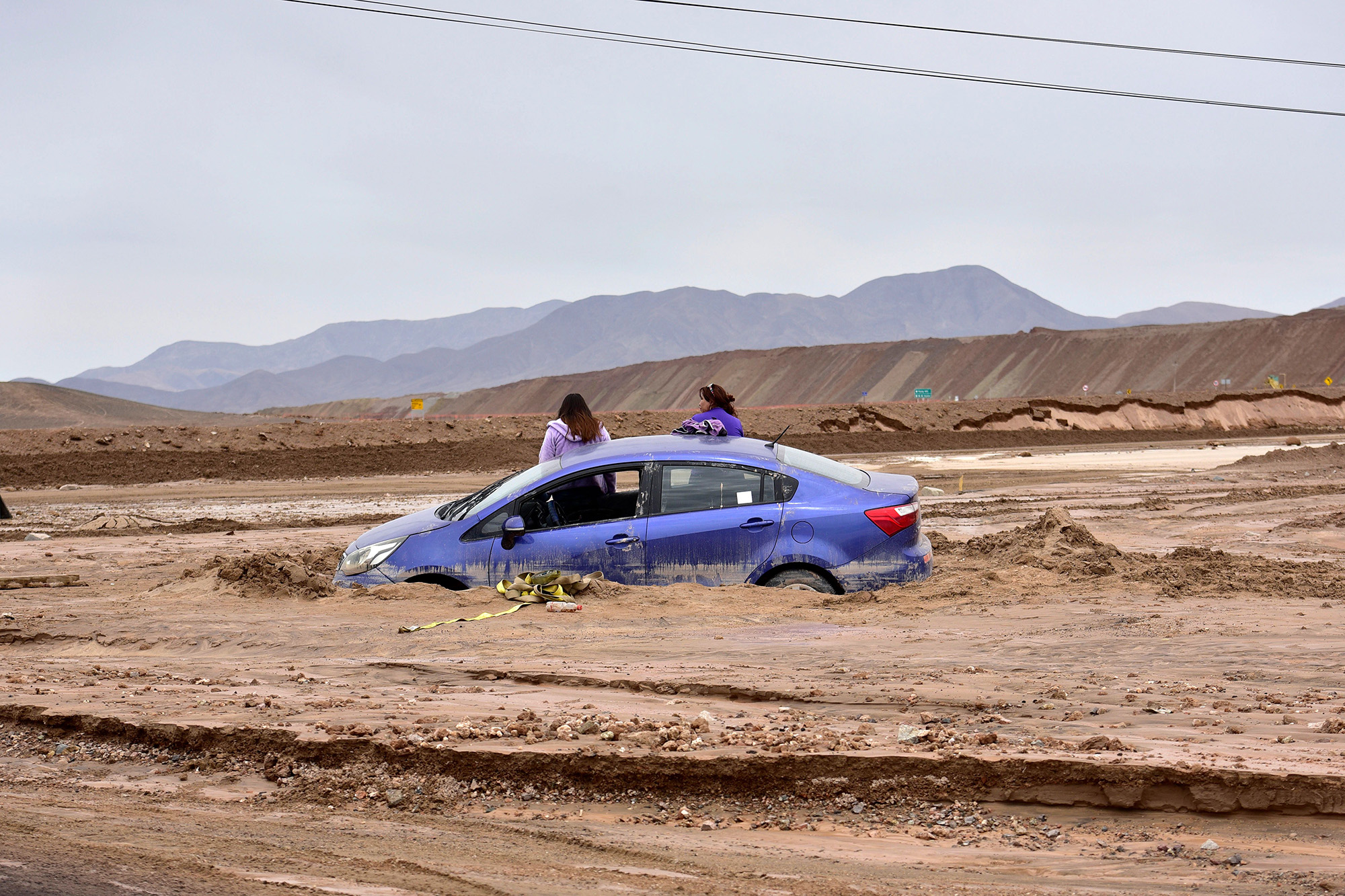A car sits trapped in mud in Chuquicamata, Chile, on Feb. 7, 2019.
