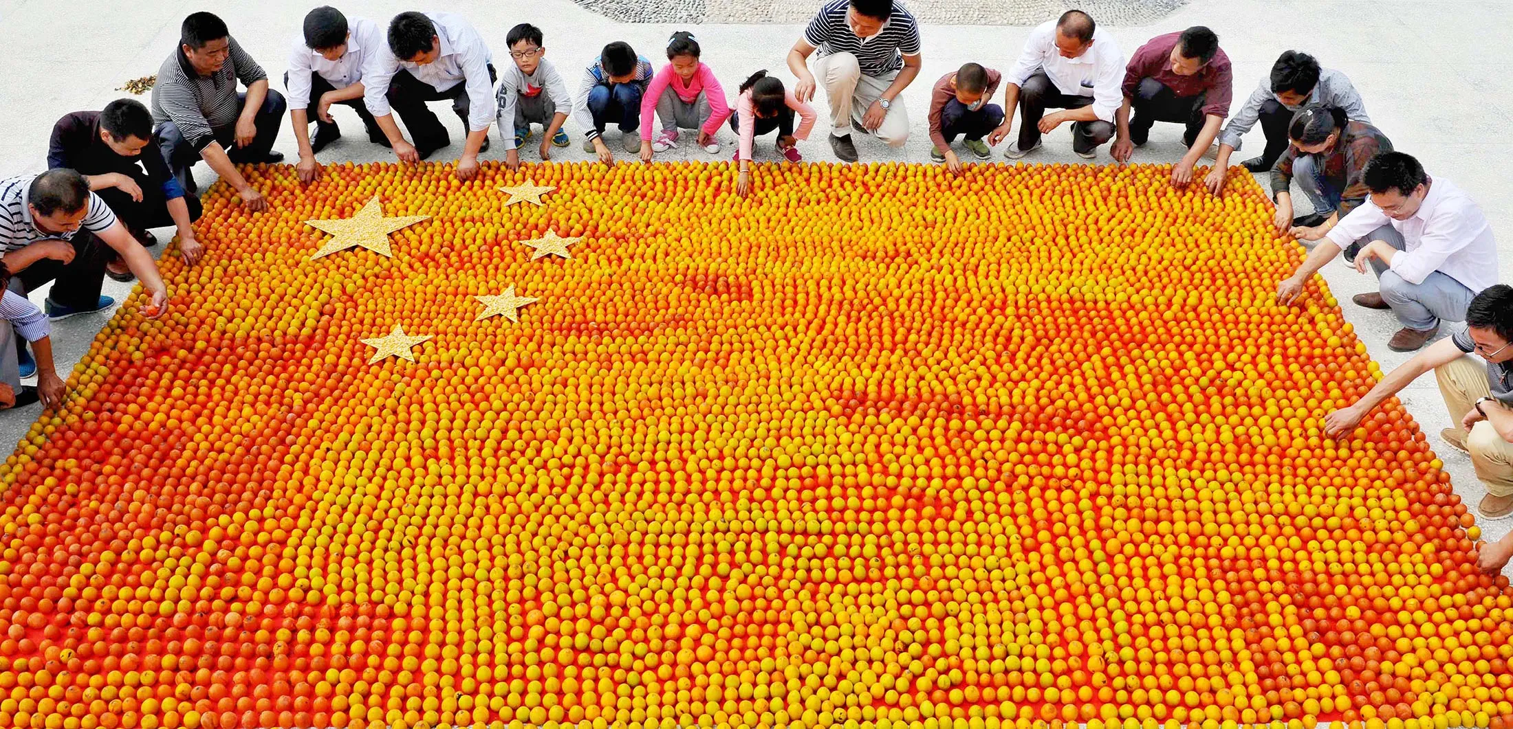 Farmers form a Chinese flag with thousands of persimmons to celebrate National Day in Shangrao, China.
