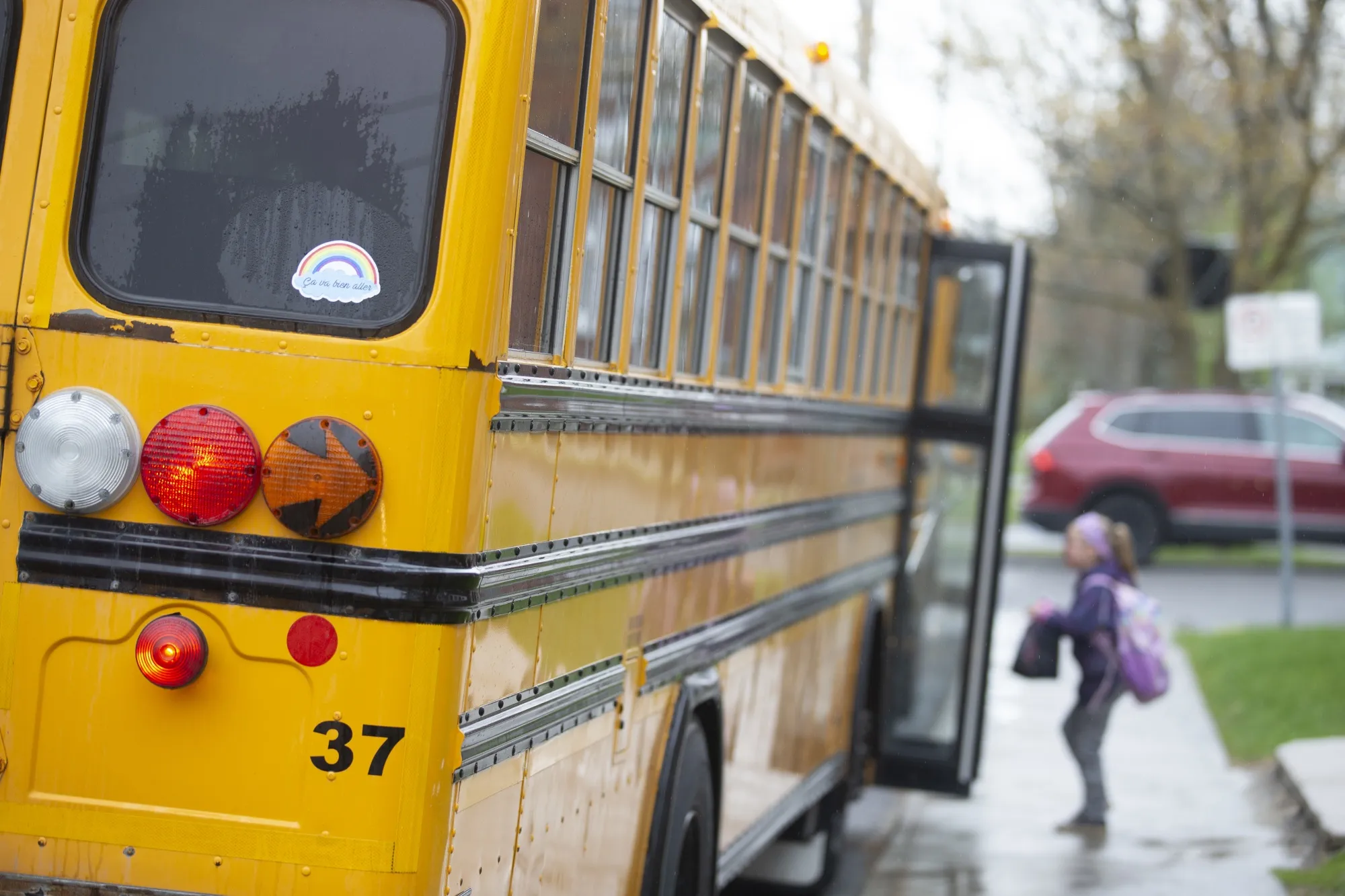 A student boards a school bus after class in Ormstown, Quebec on May 11, 2020.