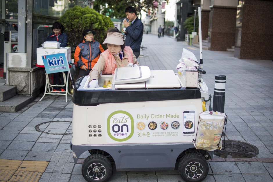 A &quot;yogurt ajumma&quot; sells cold drinks out of her motorized refrigerator.