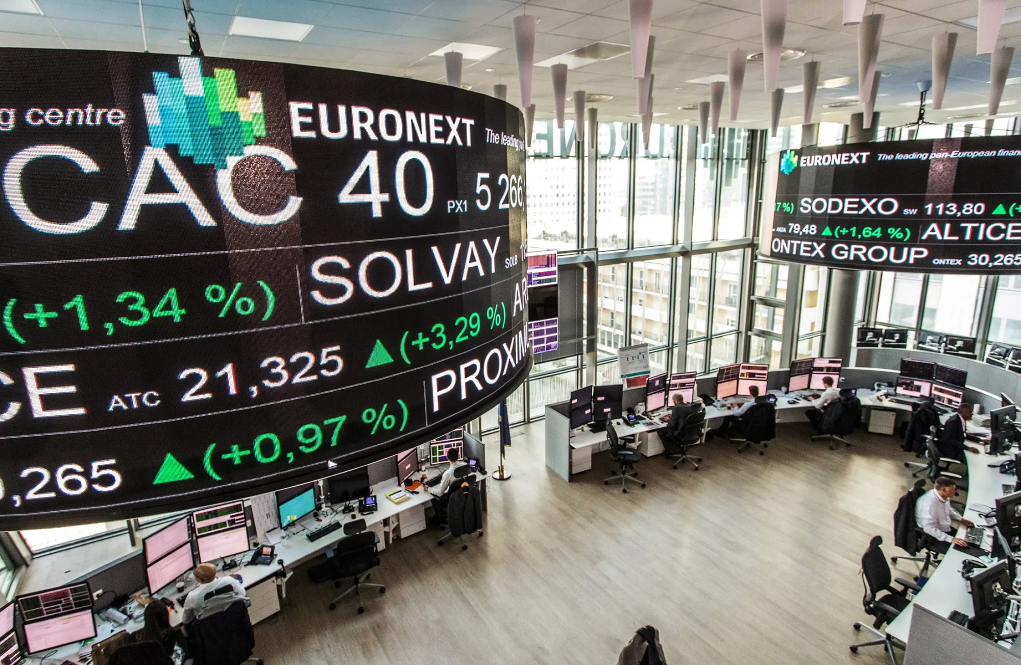 Company stock price information is displayed on a screen as it hangs above the Paris stock exchange, operated by Euronext NV, in La Defense business district in Paris, France, on Monday, April 24, 2017. France’s bonds jumped, with the 10-year yield dropping to its lowest level in three months, after centrist Emmanuel Macron and nationalist Marine Le Pen won the first round of the nation’s presidential election.
