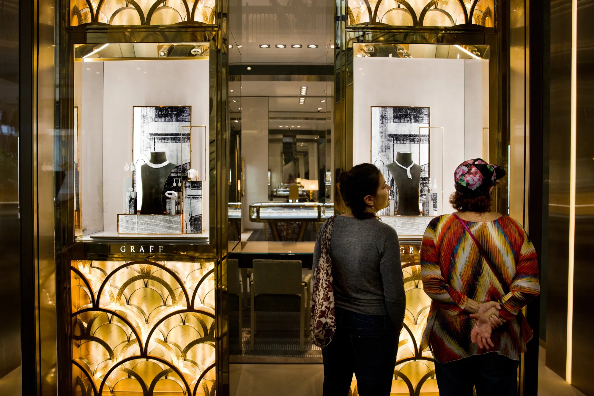 Shoppers view the Graff Diamonds Ltd. window display at the Bal Harbour Shops in Miami.