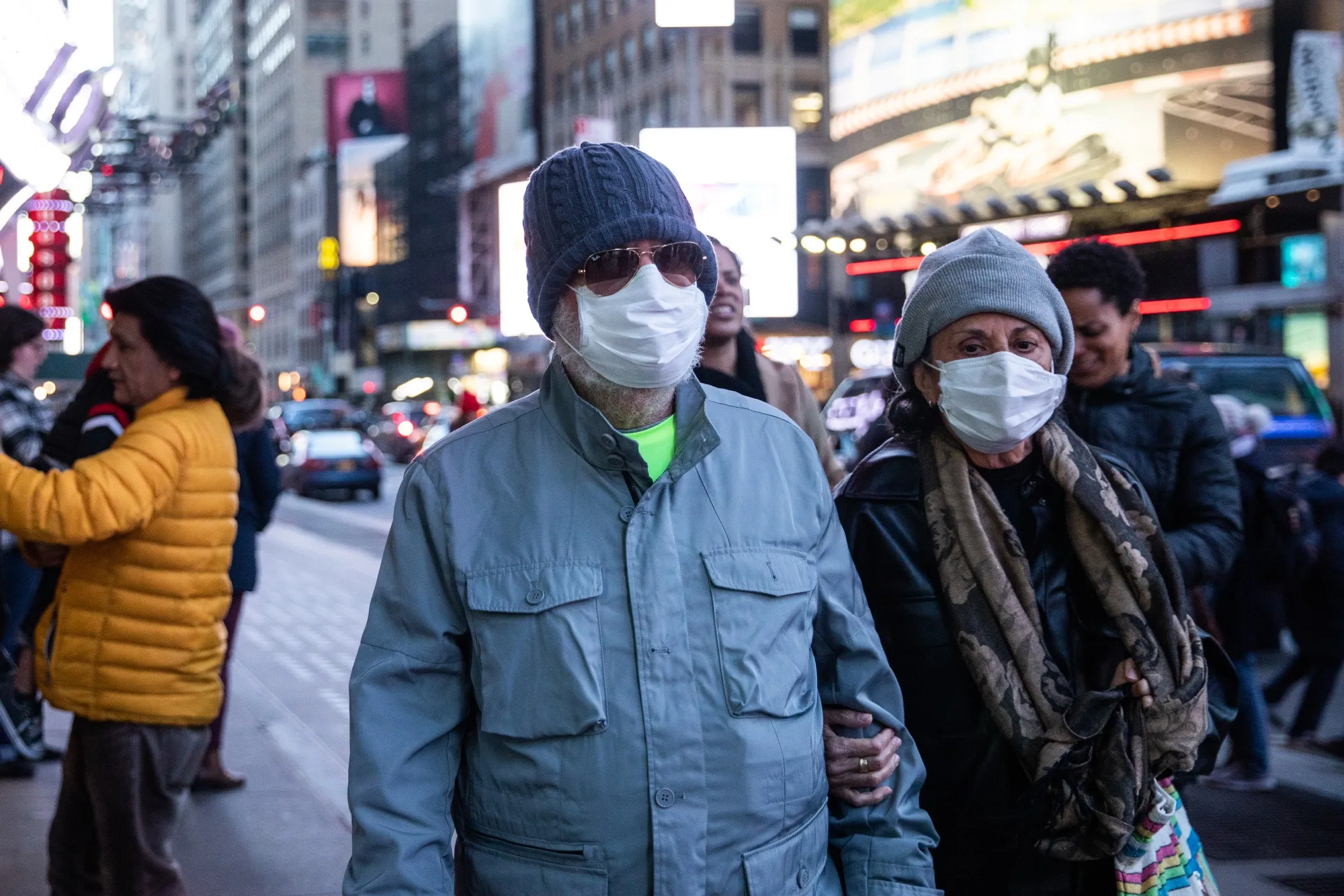 Pedestrians wear protective masks while walking in New York, March 7.