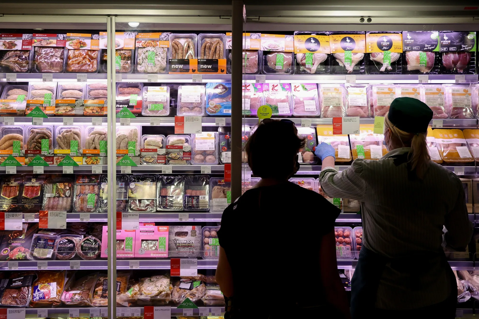 A worker arranges packets of cold cuts in a refrigerated cabinet inside an Azbuka Vkusa OOO supermarket in Moscow, Russia, on Friday, June 25, 2021. Yandex NV is in talks about buying the Azbuka Vkusa supermarket chain, The Bell reports, citing three people familiar with the situation.