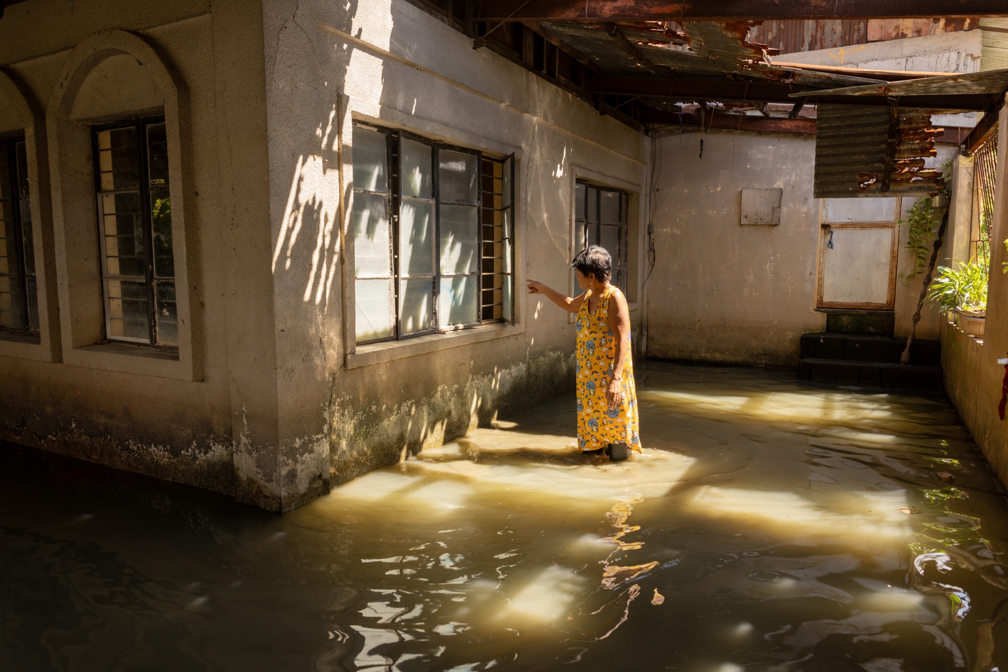 A resident in a flooded home in Barangay Frances in Calumpit, Bulacan, the Philippines on Satruday, Dec. 06 2025. Photographer: Geric Cruz/Bloomberg