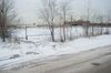 Same field behind a fence, covered in snow