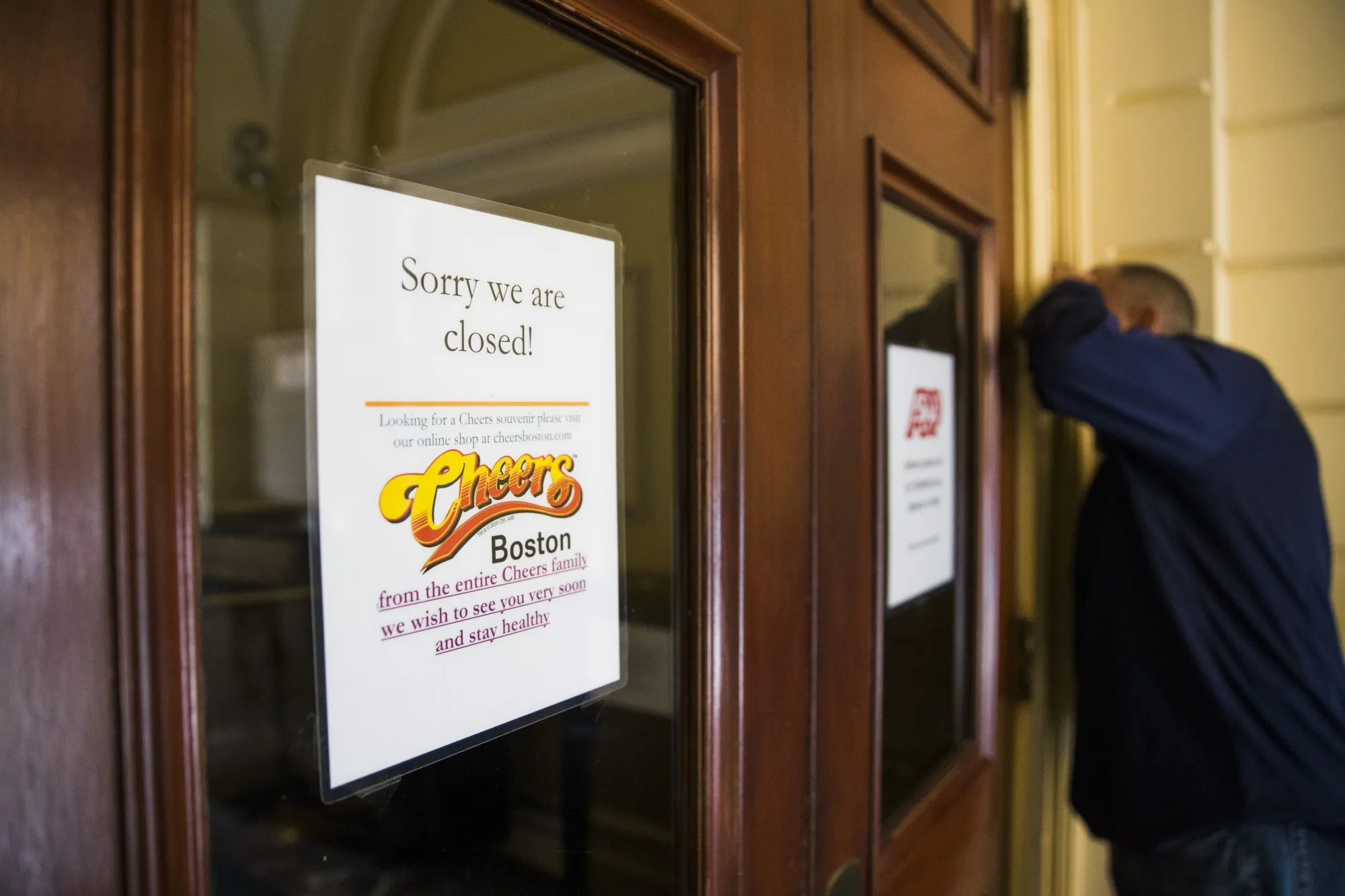 A closed sign hangs in the window of the Cheers Boston bar in Boston, Massachusetts, U.S., on April 1.