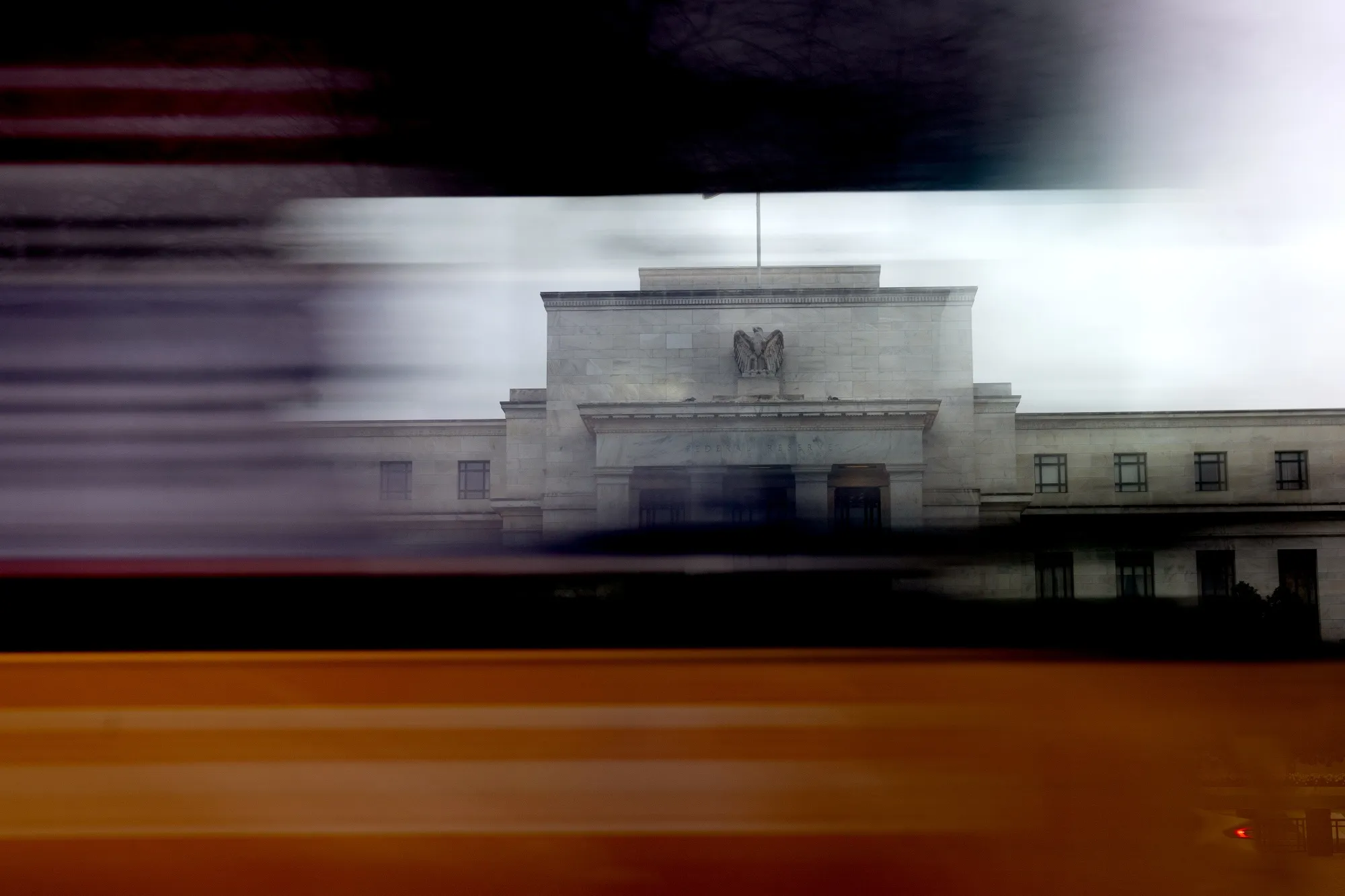 A vehicle passes the Marriner S. Eccles Federal Reserve building in Washington, D.C.