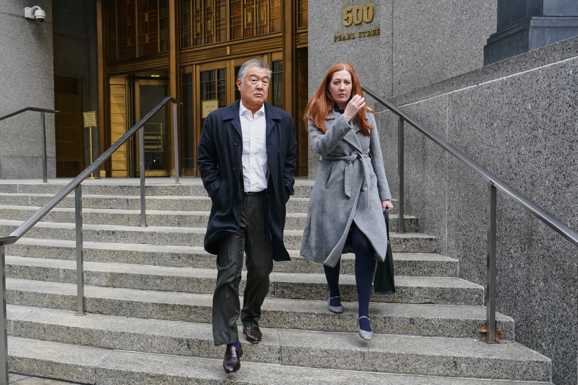 Daniel Chu, center, departs federal court in New York on Jan. 13.