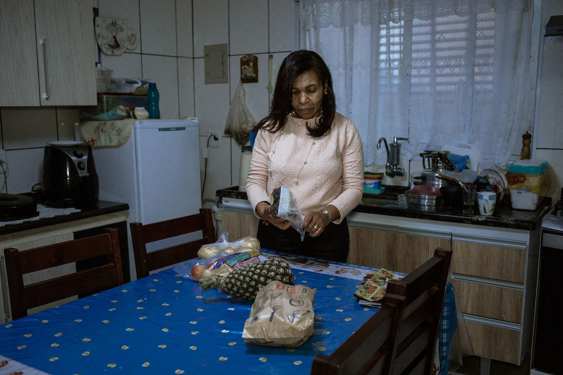 Izabel Francisca Teixeira Valdeci unpacks groceries at her home in Guarulhos, Brazil.