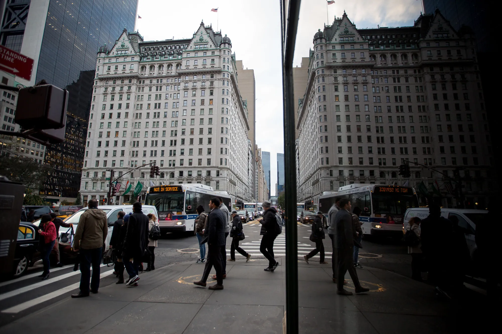 Pedestrians walk near the Plaza Hotel in New York.