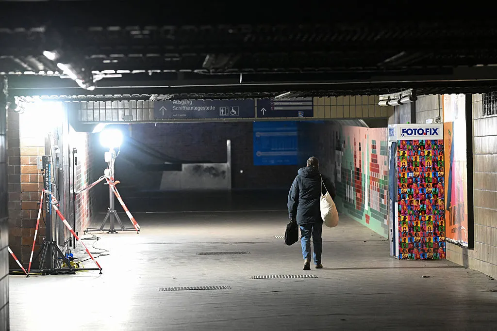 A commuter walks along a passage in a train station iluminated by the Federal Agency for Technical Relief due to power outage,&nbsp;Jan. 4.
