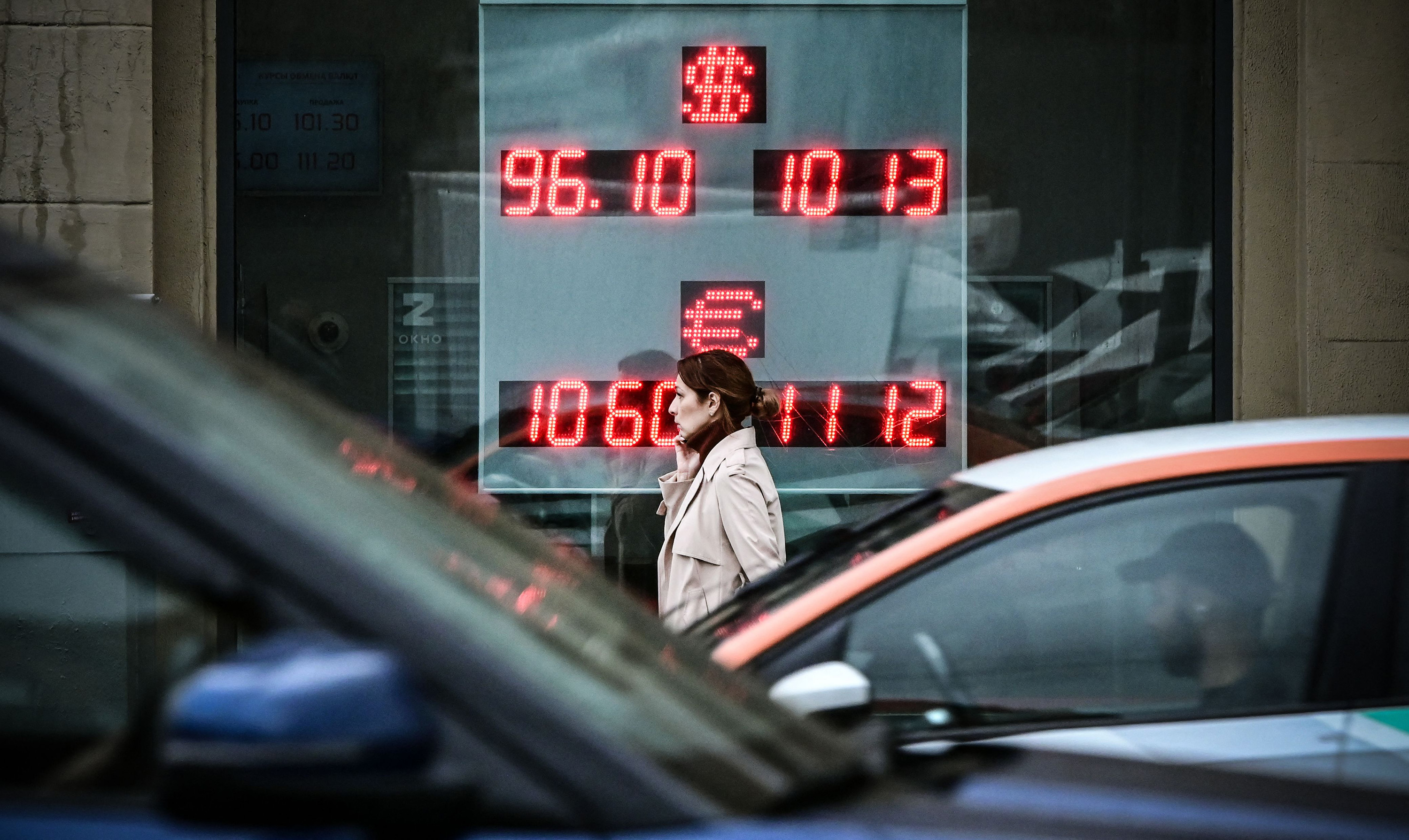 A pedestrian passes a currency exchange office in Moscow on Aug. 14.