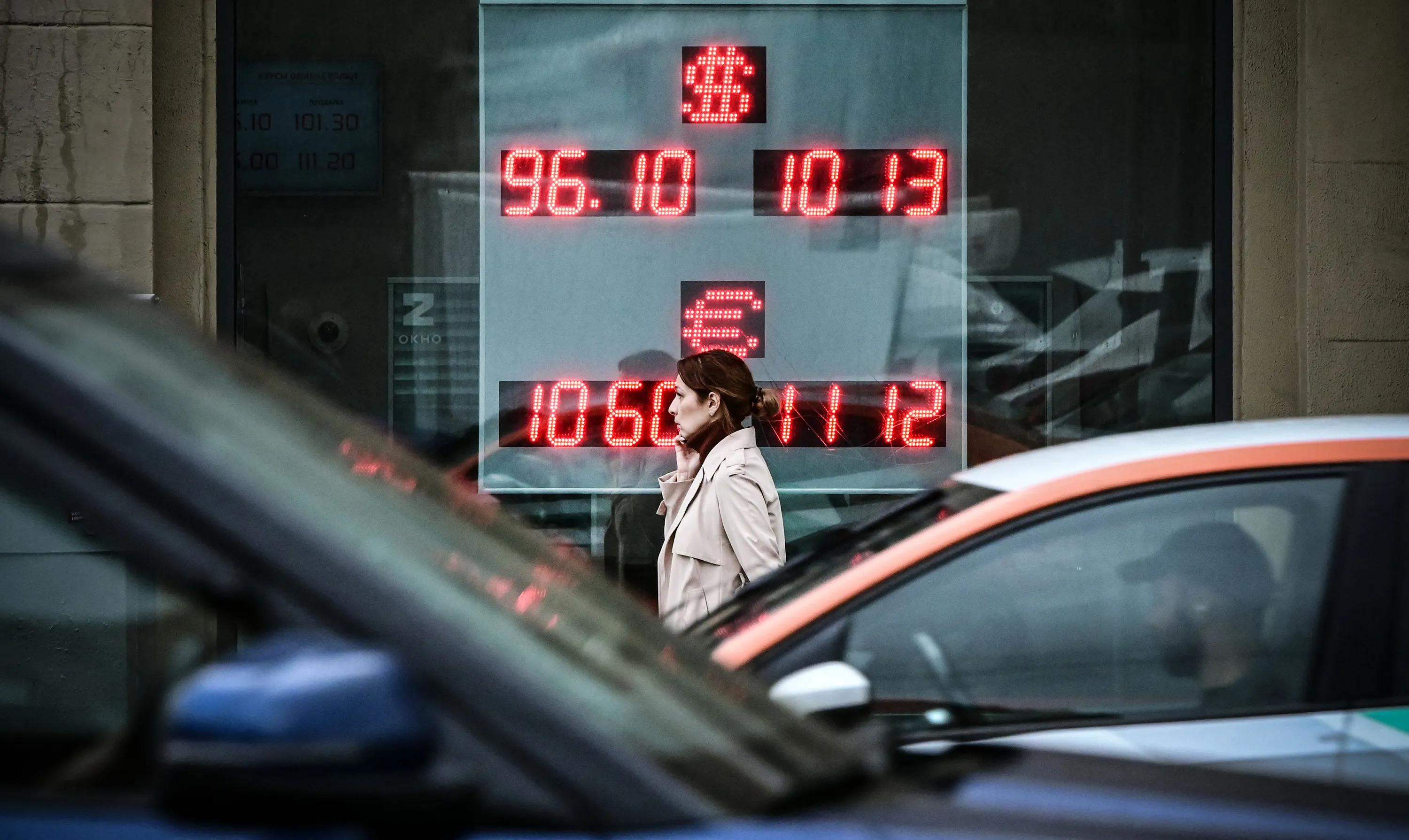 A pedestrian passes a currency exchange office in Moscow on Aug. 14.