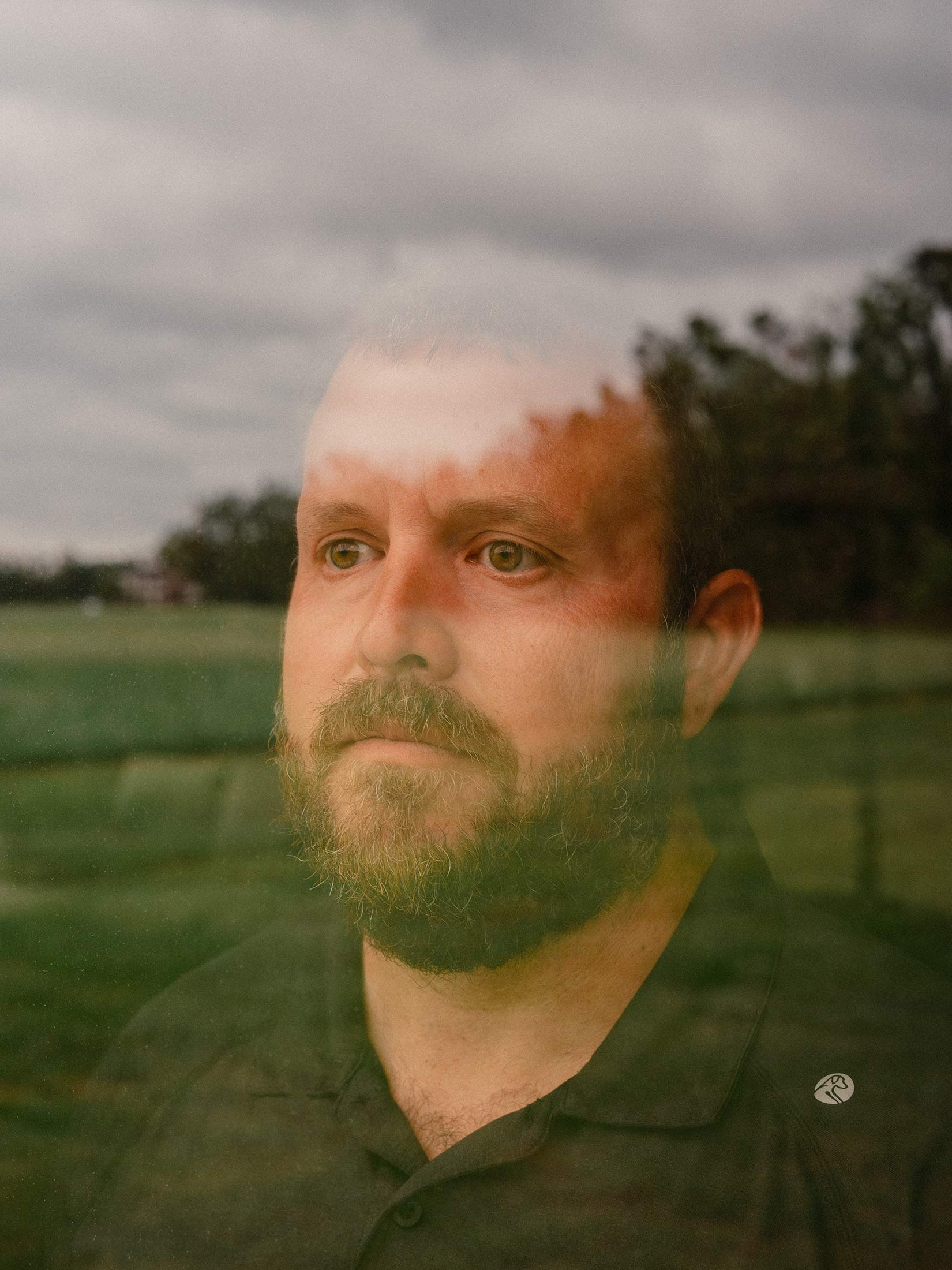 A portrait of Dustin Morris, a corn and soybean farmer who’s weighing whether to sell land his family has held for generations.