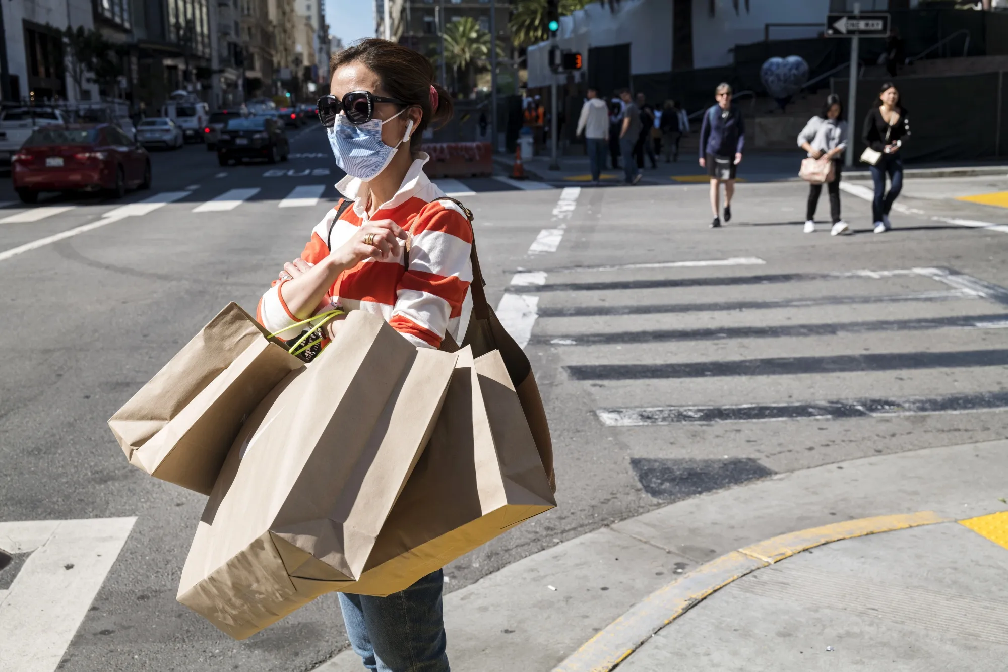 A pedestrian carries shopping bags in San Francisco on March 4.