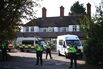 Police officers gaurd the The Bell Hotel in Epping, UK.