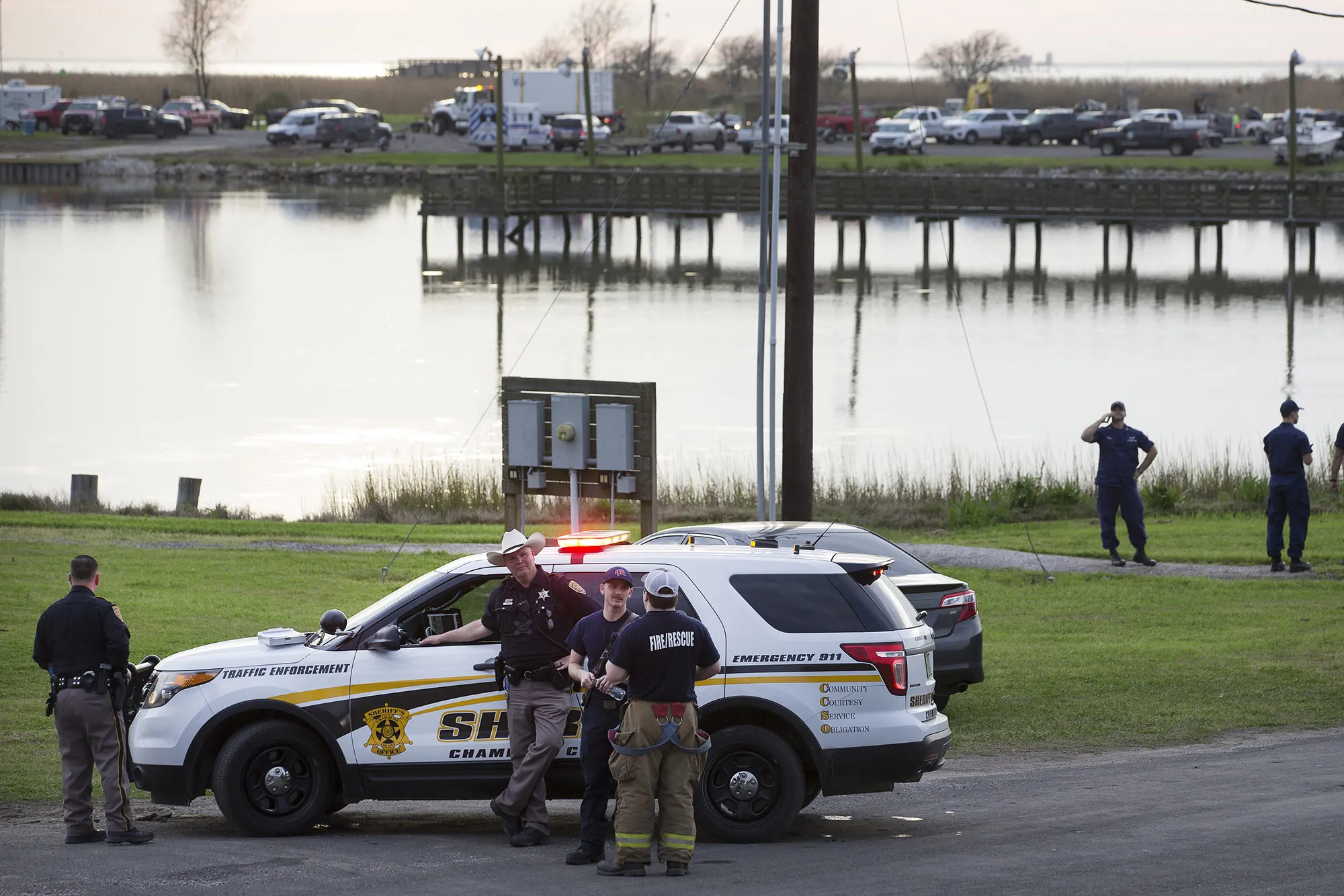 Police man a road block during the investigation of a plane crash in Trinity Bay in Anahuac, Texas, Feb. 23, 2019.