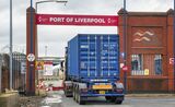 A lorry carrying a shipping container arrives at the Port of