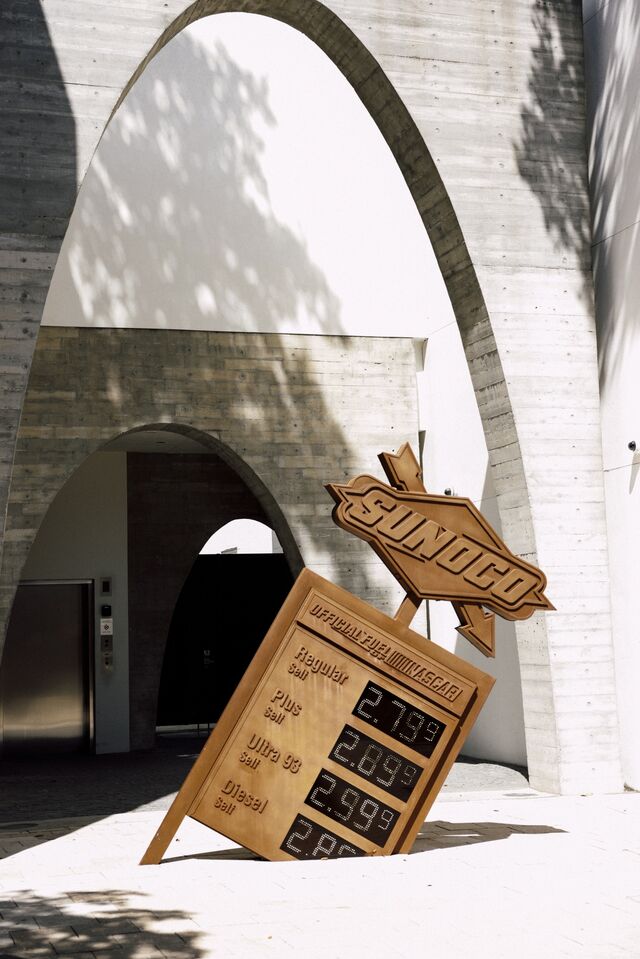 'Dollar A Gallon III' sculpture by artist Virgil Abloh that resembles a a gasoline sign relaying information about various types of gasoline sign with prices.