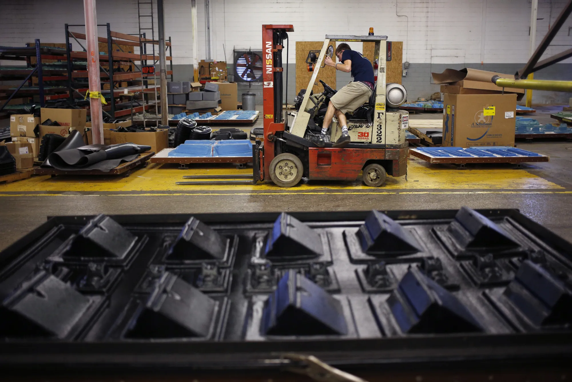 An employee climbs into a forklift at a&nbsp;kayak factory in&nbsp;Tennessee.