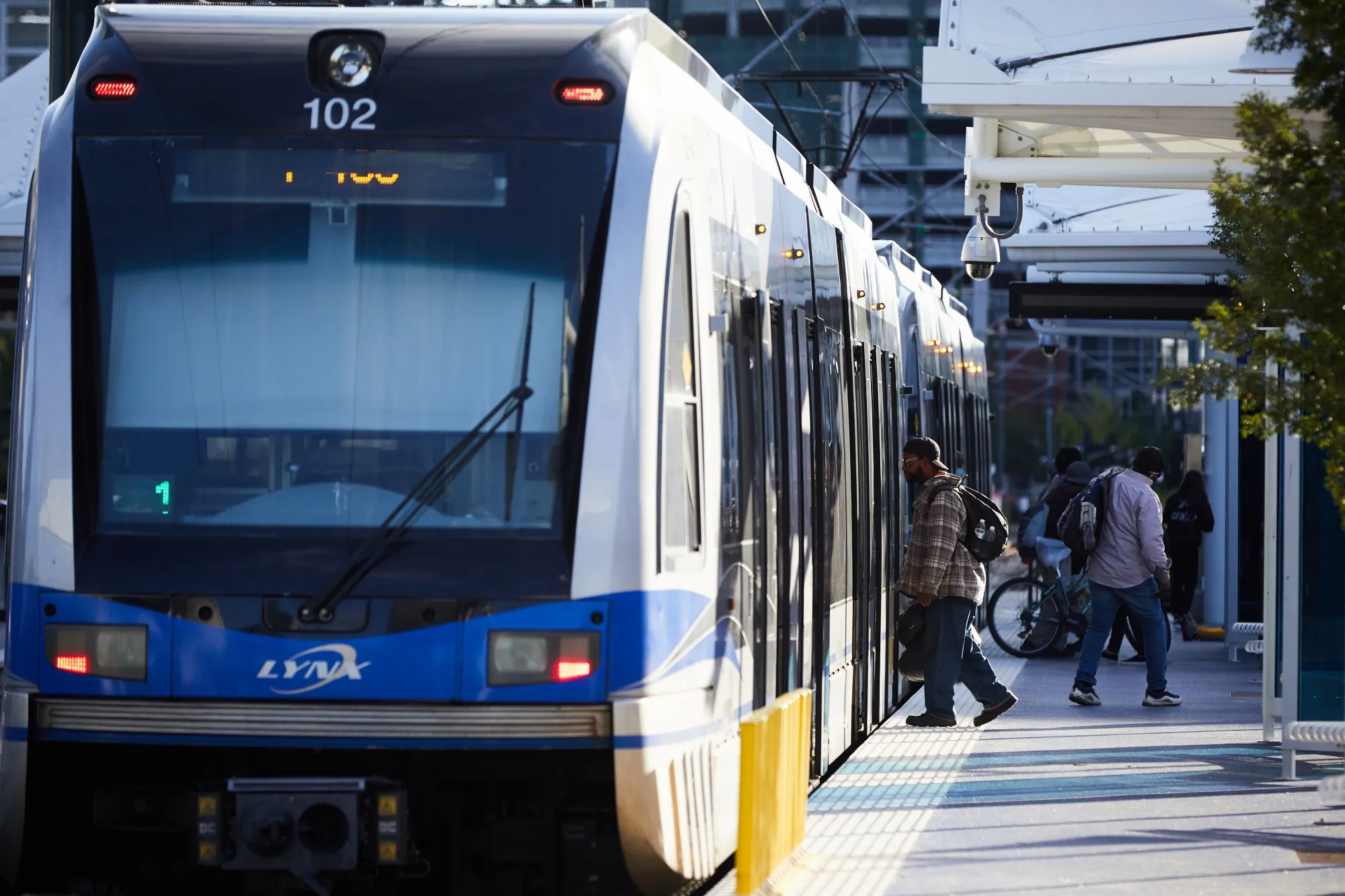 A commuter boards a light rail at a stop in Charlotte, North Carolina.