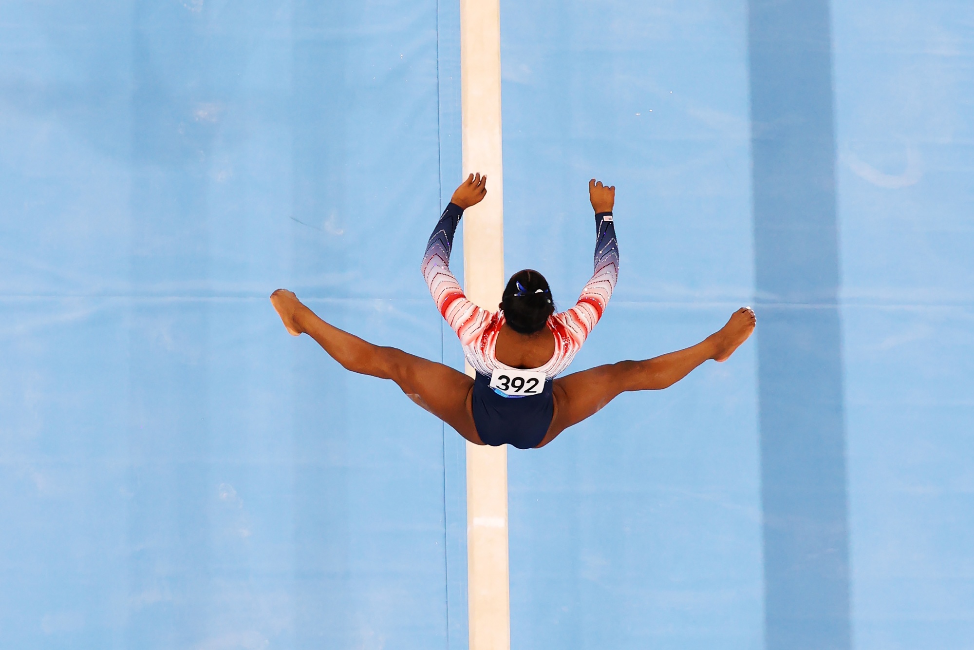 Russian gymnast stands on the podium with symbol supporting