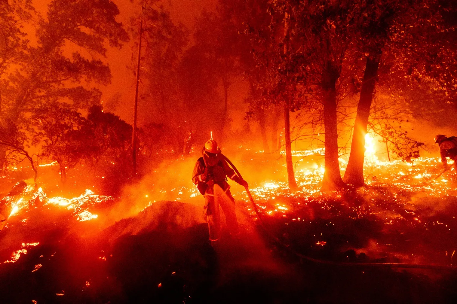 A firefighter battles the North Complex fire in Madera County, California.