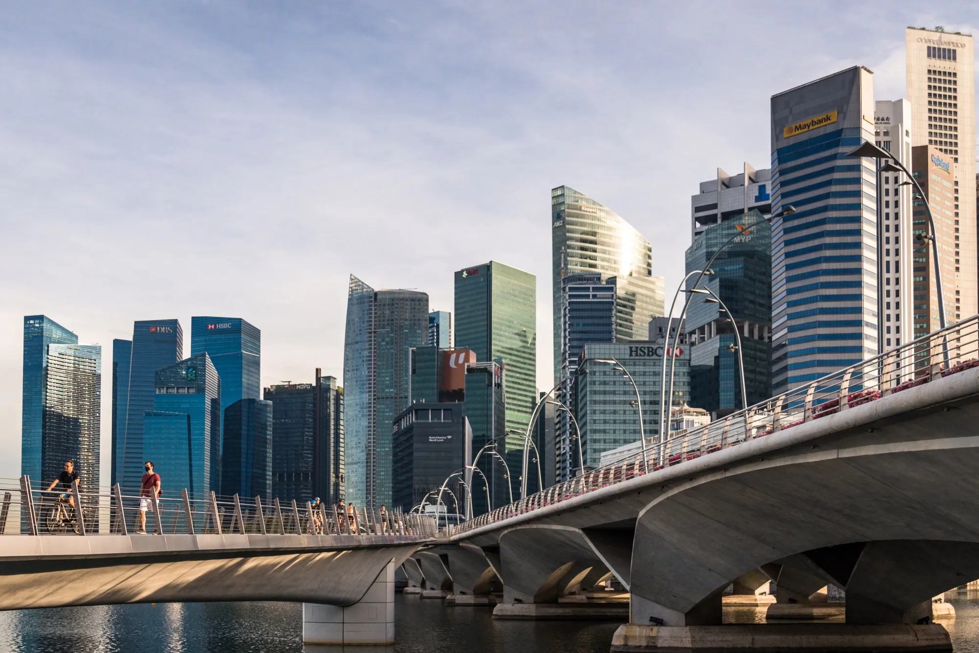 Pedestrians walk along the Jubilee Bridge in the central business district&nbsp;in Singapore.