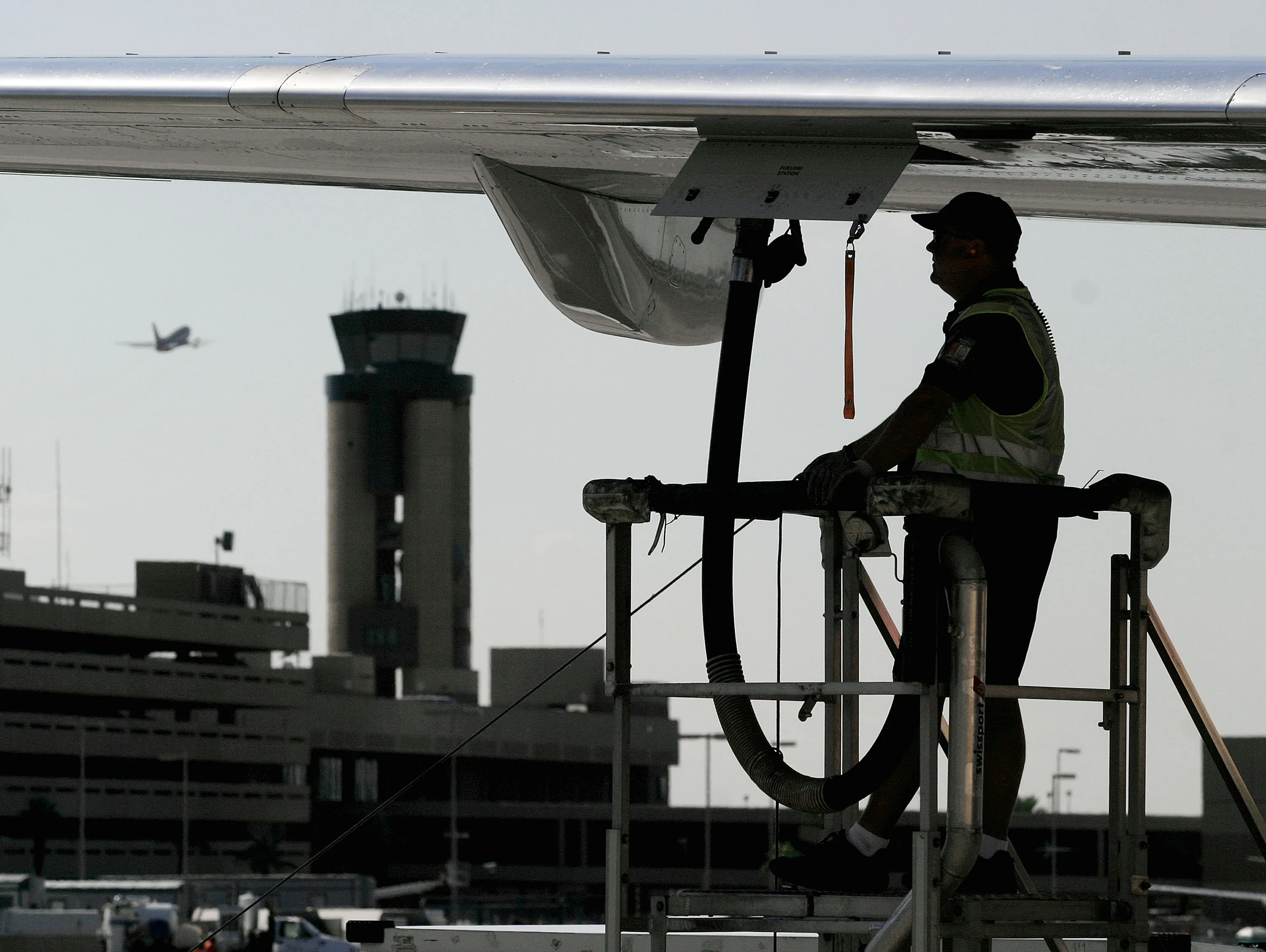 A ground crew worker refuels a plane at Phoenix Sky Harbor International Airport in Arizona.