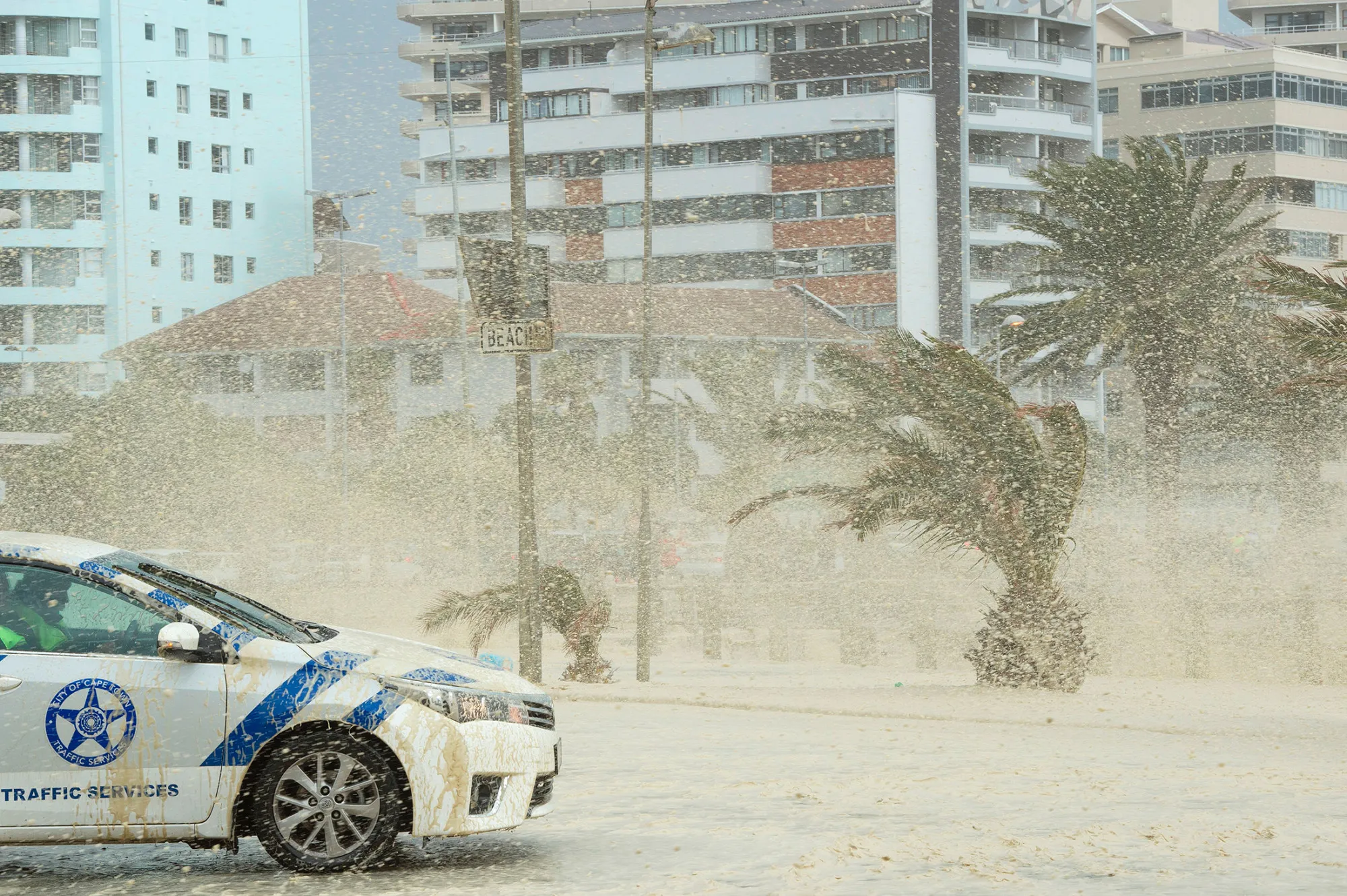 Waves of foam and seawater crash into Three Anchor Bay in Cape Town on June 7.
