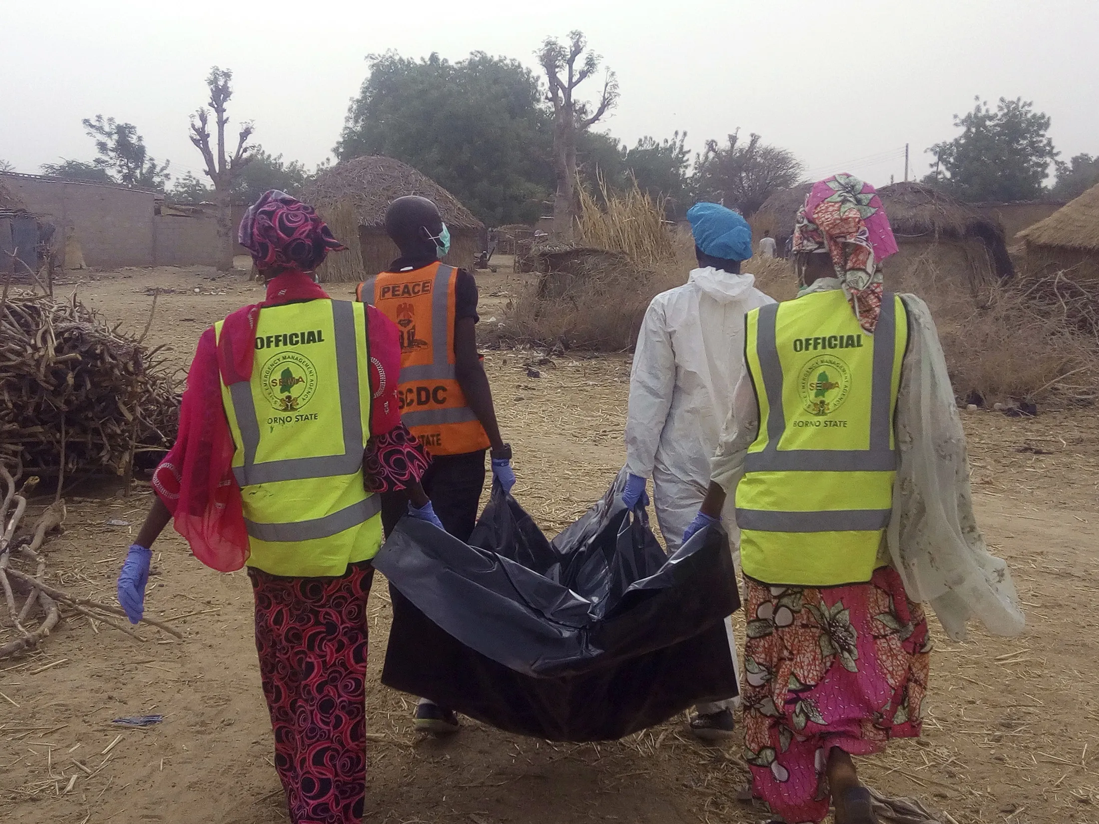 Rescue workers carry a&nbsp;victim of a Boko Haram attack in 2018.