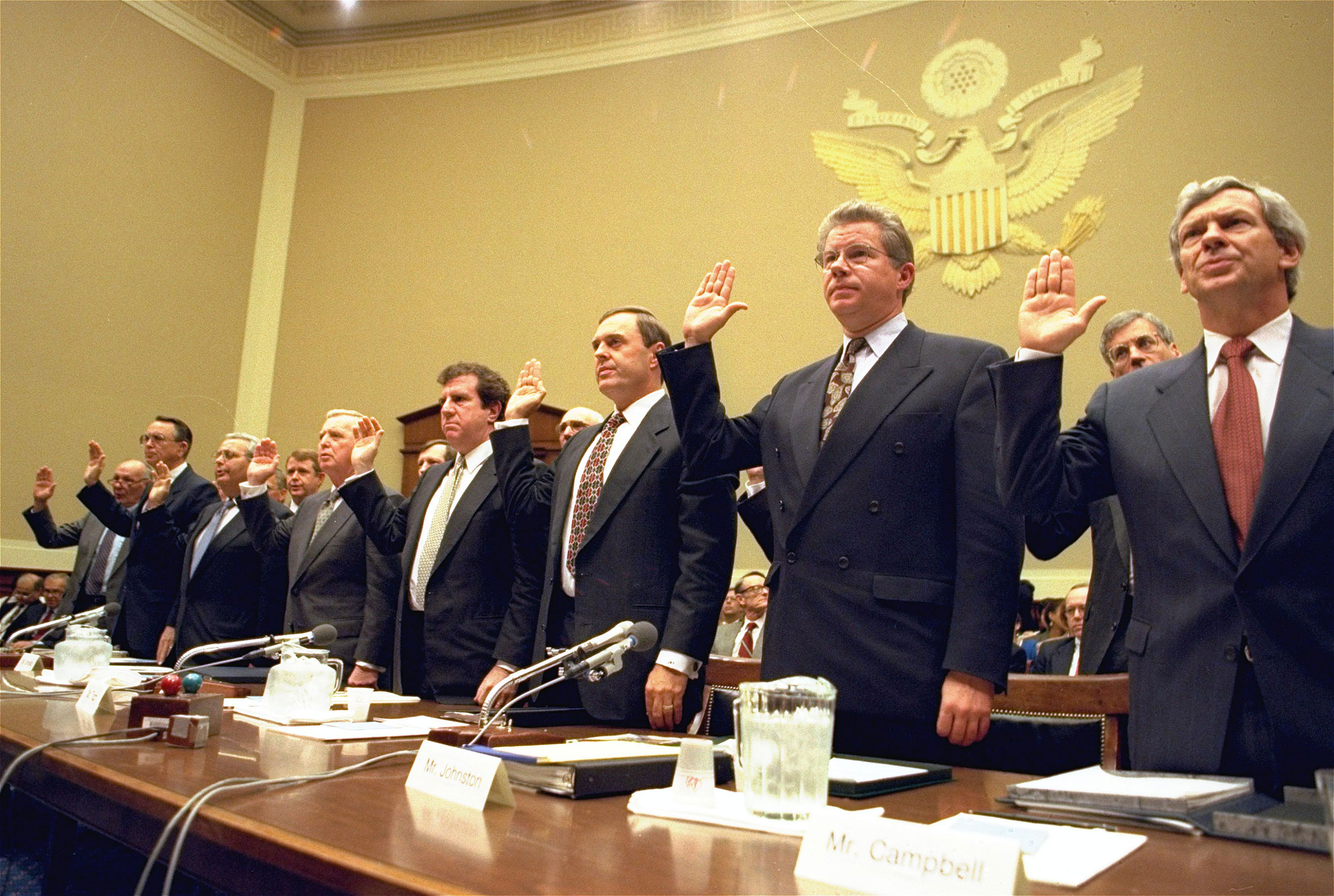 Heads of the nation's largest cigarette companies are sworn in before a hearing of a House Energy subcommittee which was holding hearings on the contents of cigarettes on Capitol Hill in Washington. More than 40 states brought lawsuits demanding compensation for the costs of treating smoking-related illnesses. Big Tobacco settled in 1998 by agreeing to pay about $200 billion and curtail marketing of cigarettes to youths. From left are Robert Sprinkle III, executive vice president for Research American Tobacco Co.; Donald Johnston, American Tobacco; Thomas Sandefur Jr., Brown and Williamson Tobacco Corp.; Edward Horrigan Jr., Liggett Group Inc.; Andrews Tisch, Lorillard Tobacco Co.; Joseph Taddeo, U.S. Tobacco Co.; James Johnston, RJ Reynolds; and William Campbell, Phillip Morris USA. April 14, 1994. Photographer: John Duricka/AP Photo